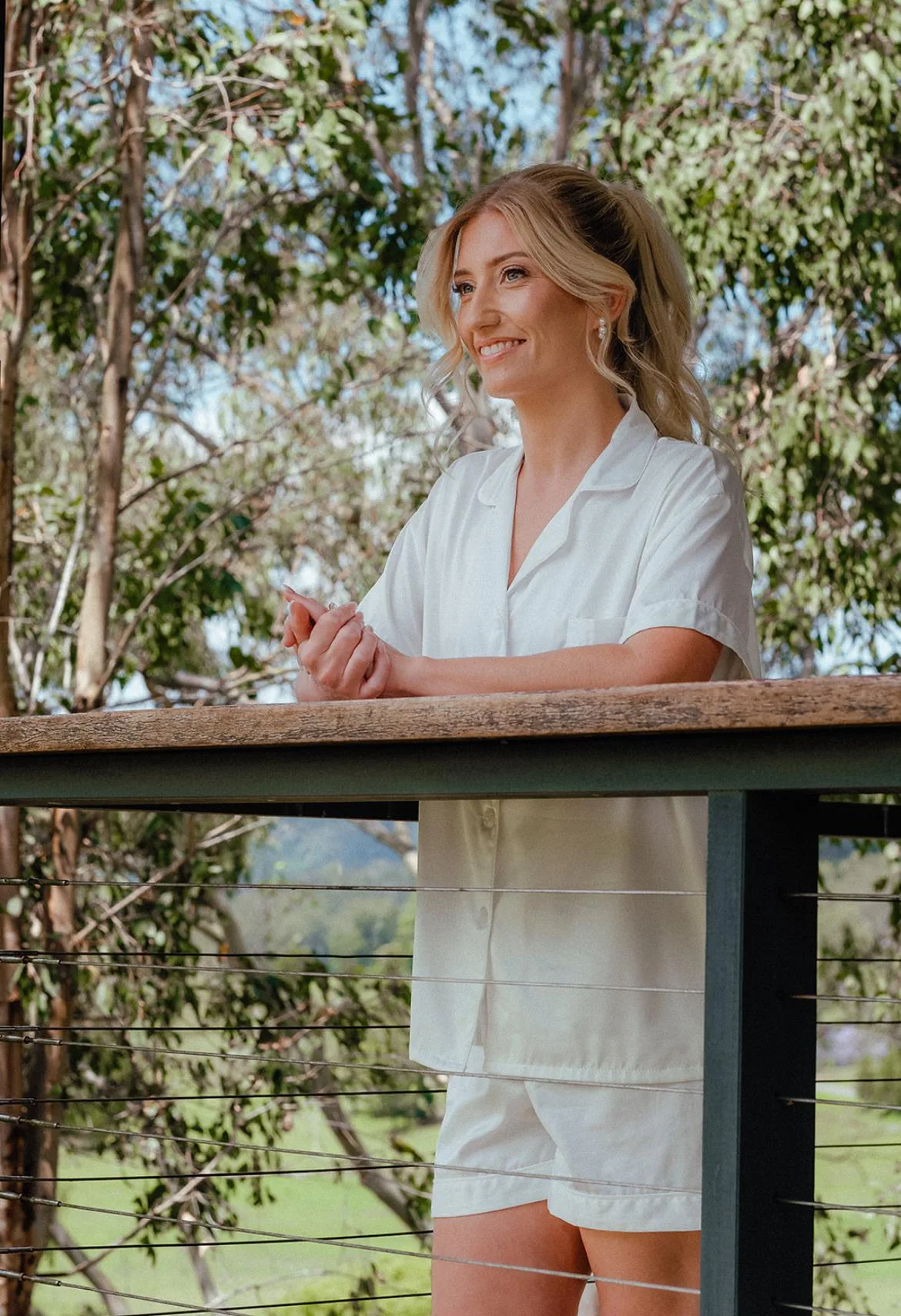 Bride on Hinterland venue balcony, morning light